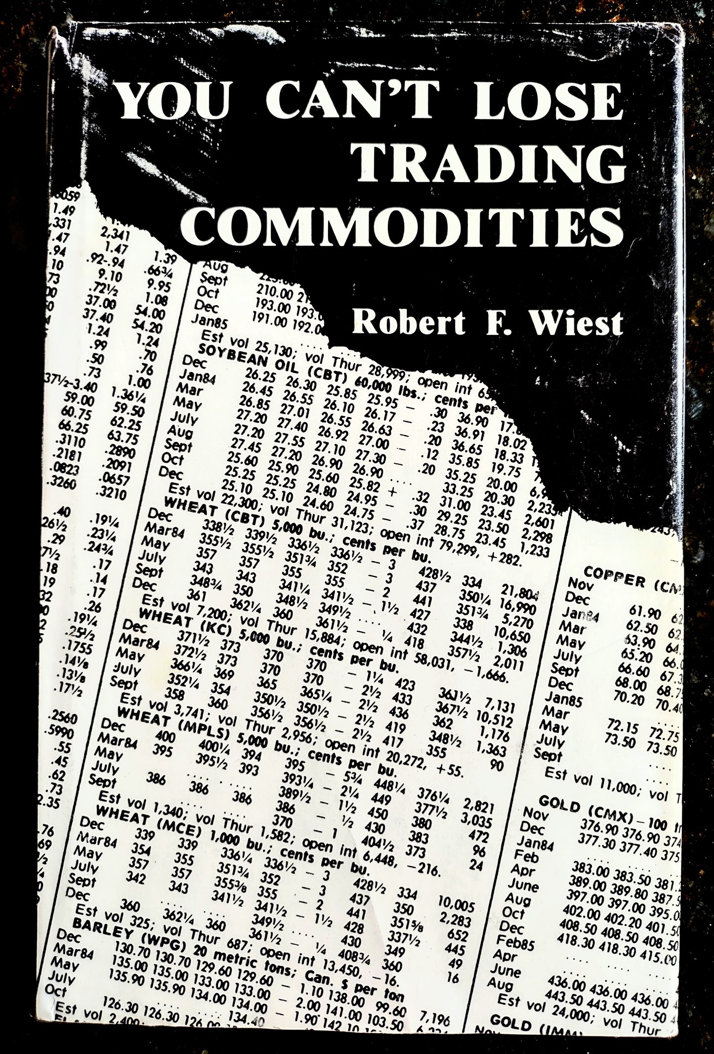 Book cover of 'You Can't Lose Trading Commodities' by Robert F. Wiest with a black and white price list.