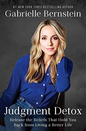 Book cover featuring a woman in a blue shirt with text about 'Judgment Detox' by Gabrielle Bernstein.