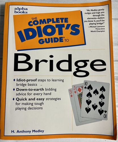 Book cover of 'The Complete Idiot's Guide to Bridge' by H. Anthony Medley on a wooden surface.