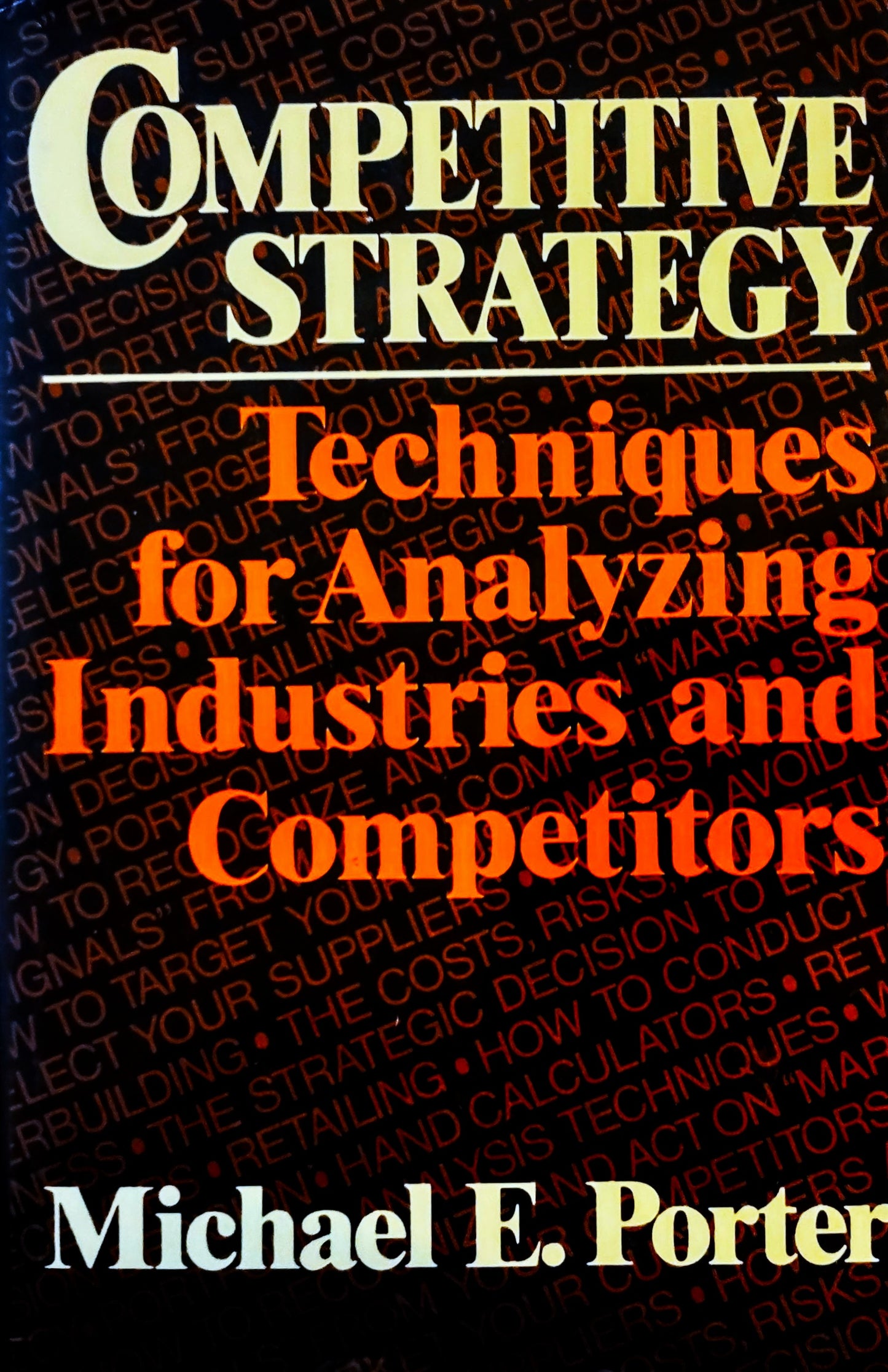 Book cover of 'Competitive Strategy' by Michael E. Porter with text on a black background.