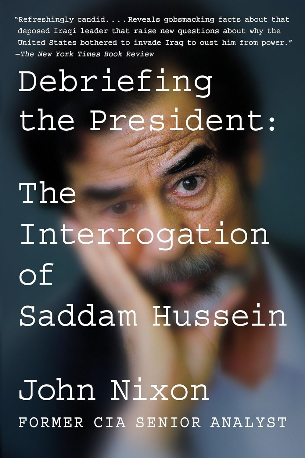 This image features the cover of the book titled "Debriefing the President: The Interrogation of Saddam Hussein" by John Nixon. The cover design is straightforward and powerful, utilizing a close-up photograph of Saddam Hussein, a prominent figure known for his role as the former president of Iraq.