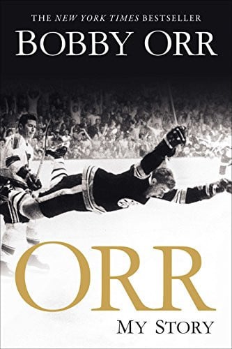 Book cover for 'ORR: My Story' by Bobby Orr, featuring a black-and-white hockey scene with a player diving across the ice, large gold 'ORR' text, and white title text on a black-and-white background.
