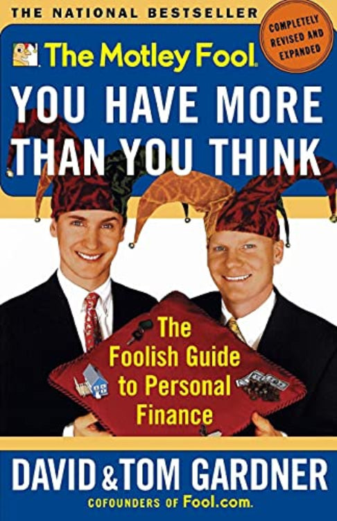 The cover of the book 'The Motley Fool: You Have More Than You Think' by David & Tom Gardner showing the authors, David and Tom Gardner, with a Foolish hat and a sign indicating it's a roadmap to financial freedom.