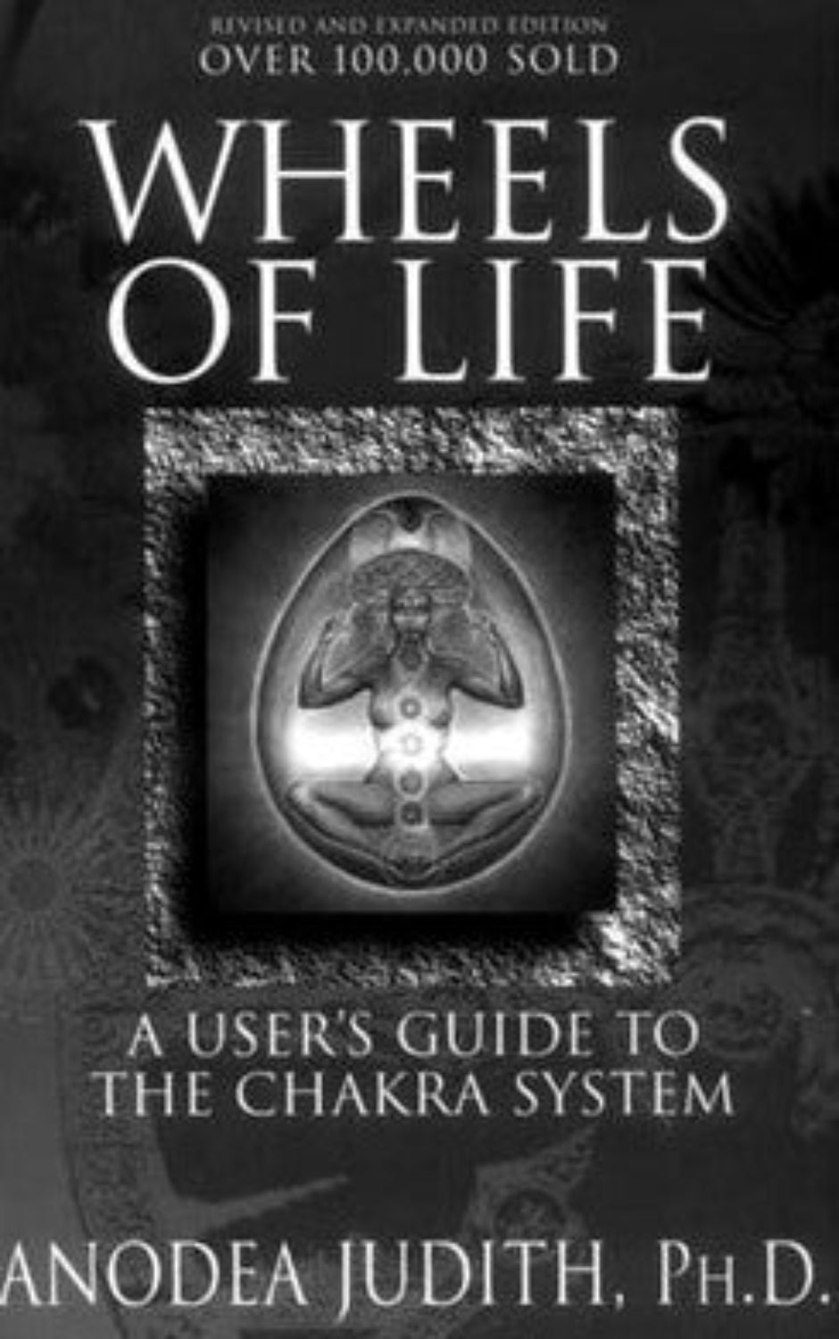 Book cover of 'Wheels of Life' by Anodea Judith with a black and white design.
