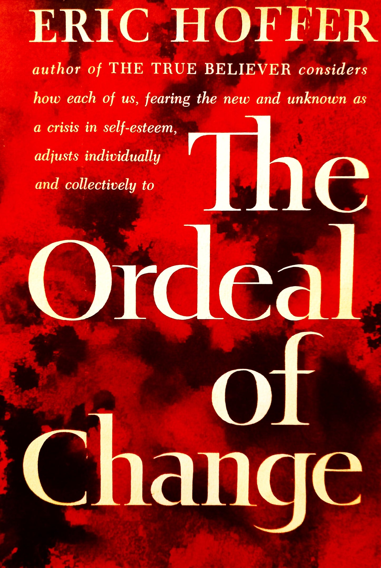 This image features the cover of "The Ordeal of Change" by Eric Hoffer, a collection of essays delving into the complex themes of philosophy, sociology, and political science. The cover design is straightforward yet compelling, with a vivid red background that enhances the white, bold lettering of the title and author's name.