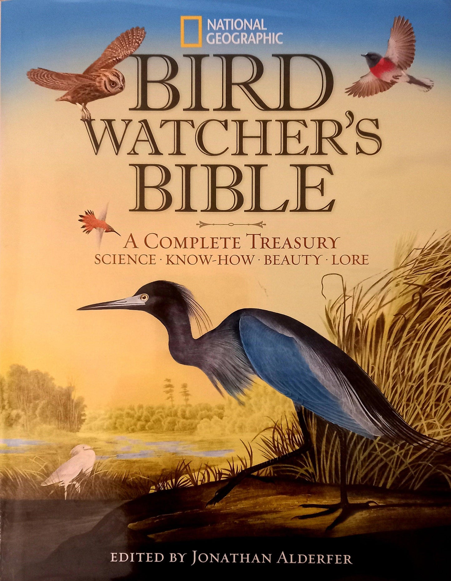 Cover of the book 'Bird Watcher's Bible' featuring an illustration of a bird in a natural setting with the title and editor's name, Jonathan K. Alderfer, prominently displayed.