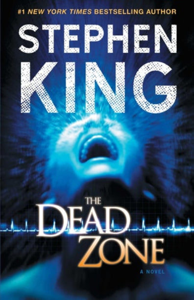 This image features the cover of "The Dead Zone," a novel by Stephen King. The cover art is dominated by a intense and blurred image of a man's face in shades of blue, creating a sense of urgency and emotional depth.