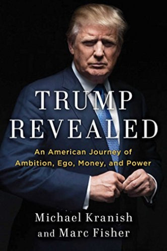 The cover of the book 'Trump Revealed: An American Journey of Ambition, Ego, Money, and Power' featuring a photograph of Donald Trump in a suit, with the title and authors, Michael Kranish and Marc Fisher, displayed at the top.