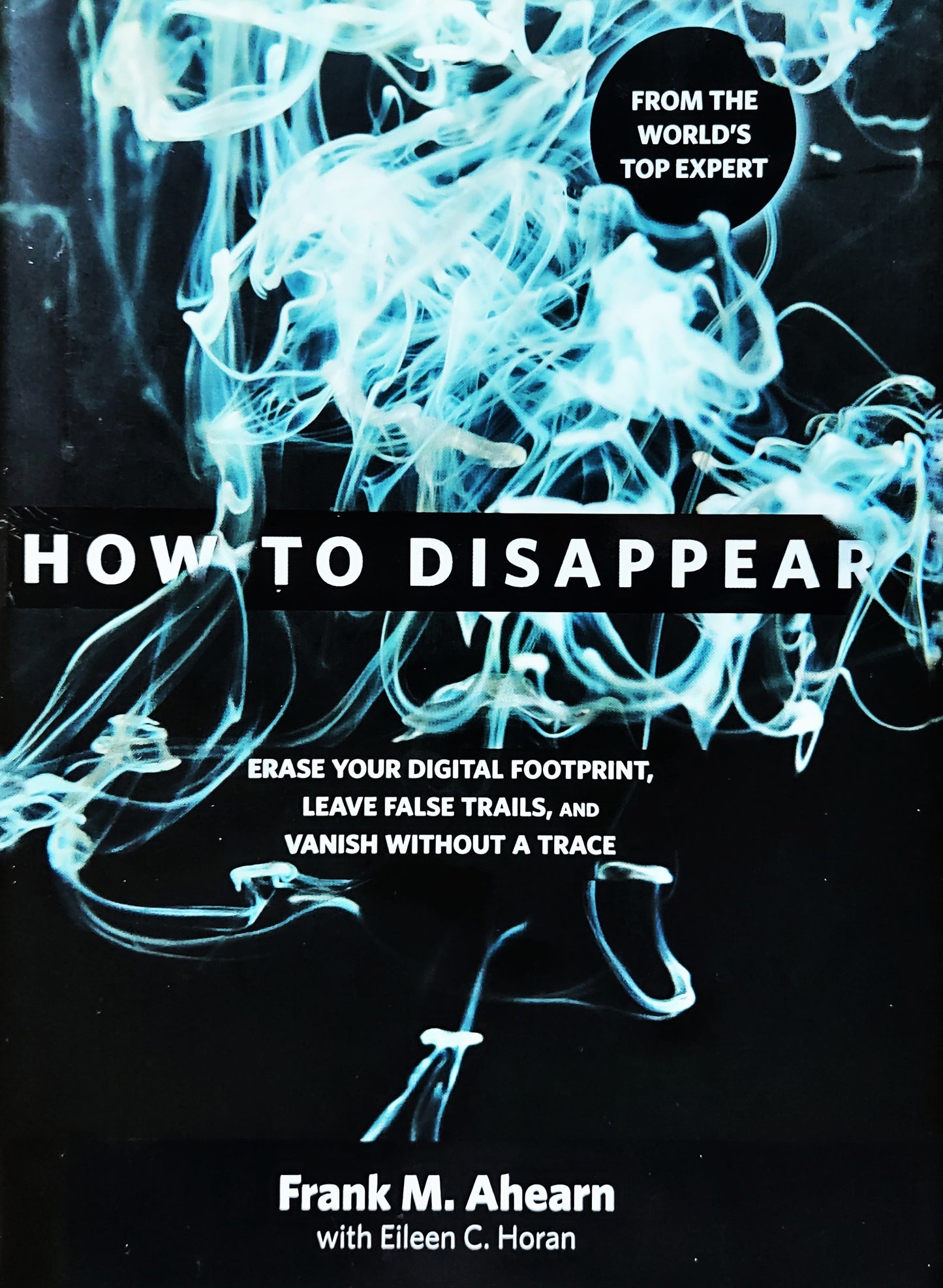 Book cover of 'How to Disappear' with blue smoke-like design on a black background