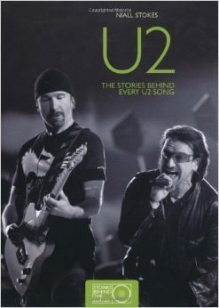 A cover image of the book titled 'U2: The Stories Behind Every U2 Song' featuring black and white photos of band members from U2 with a focus on the lead singer and guitarist.