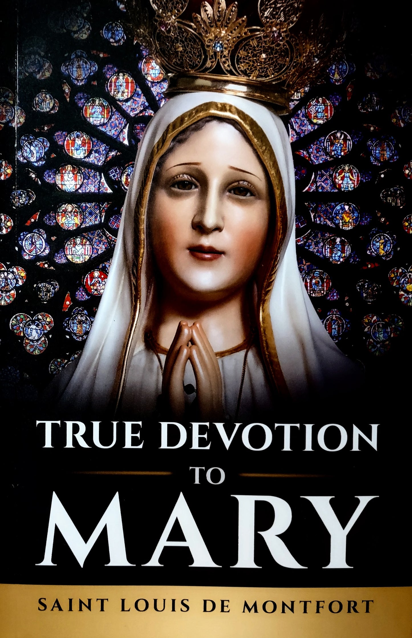 Book cover for 'True Devotion to Mary' by Saint Louis de Montfort, featuring a portrait of the Virgin Mary with a gold crown and hands in prayer, set against a stained-glass background.