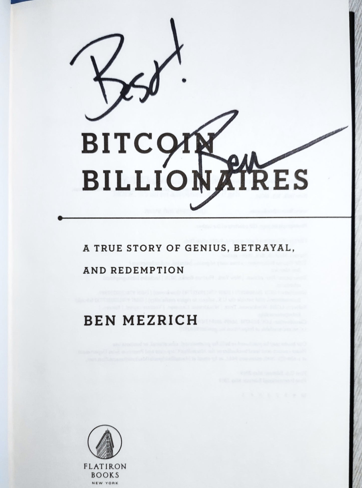 Book title page of 'Bitcoin Billionaires' by Ben Mezrich with his signature on a white page over title