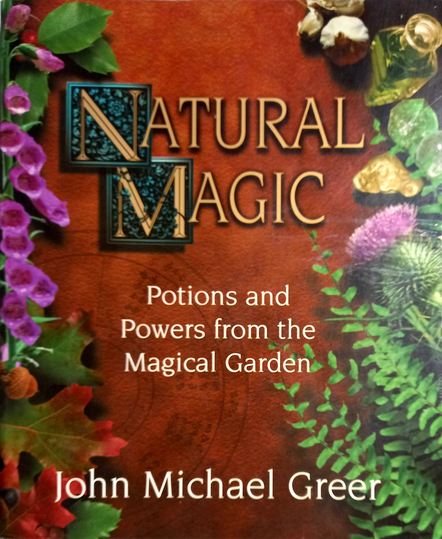 Book cover of 'Natural Magic' with herbs, flowers, and stones on a wooden background