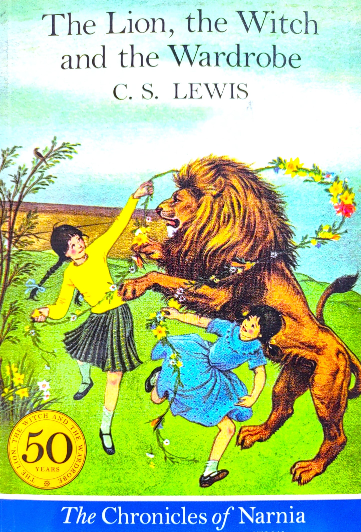 Book cover of 'The Lion, the Witch and the Wardrobe' by C.S. Lewis featuring a lion, two children, and a colorful background.