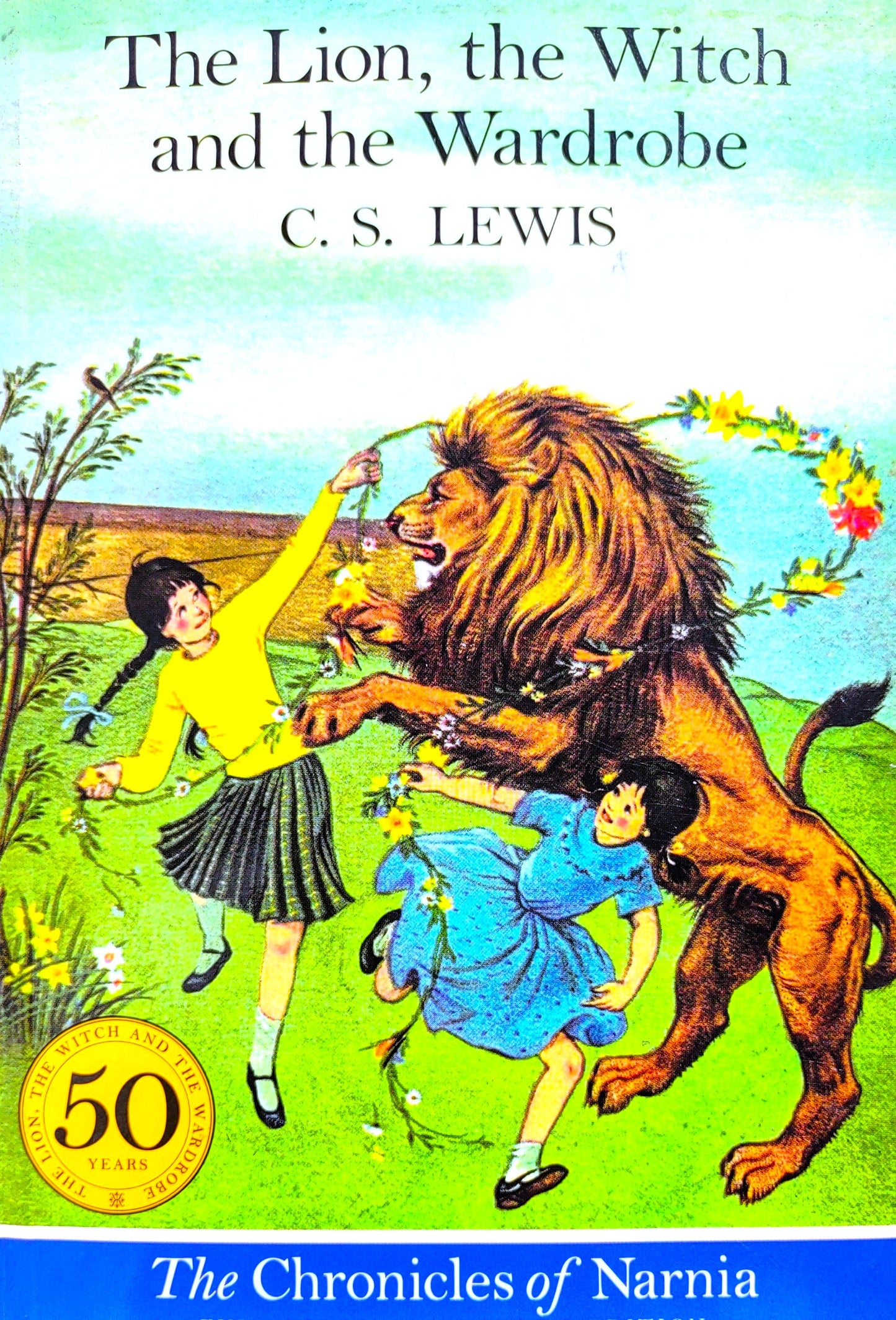 Book cover of 'The Lion, the Witch and the Wardrobe' by C.S. Lewis featuring a lion, two children, and a green background.