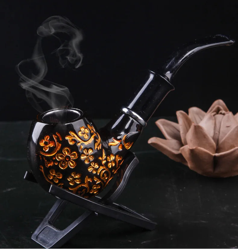 Decorative smoking pipe with intricate designs on a dark background