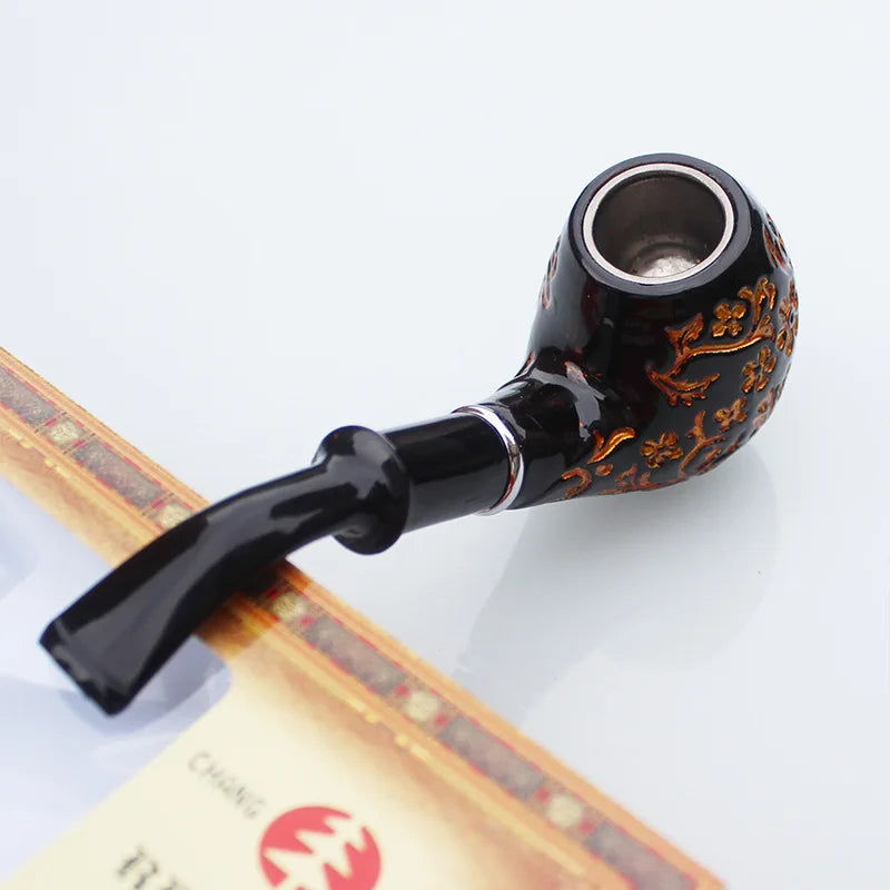 Decorative smoking pipe with intricate designs on a white background