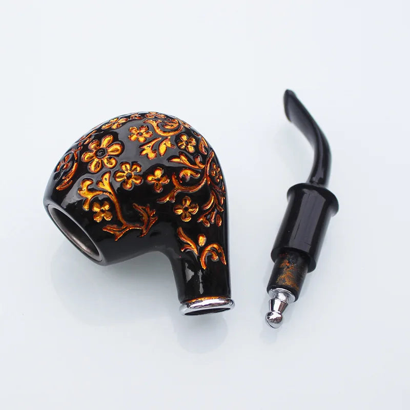 Decorative black and gold smoking pipe on a white background