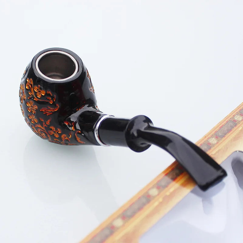 Decorative smoking pipe with intricate design on a white background