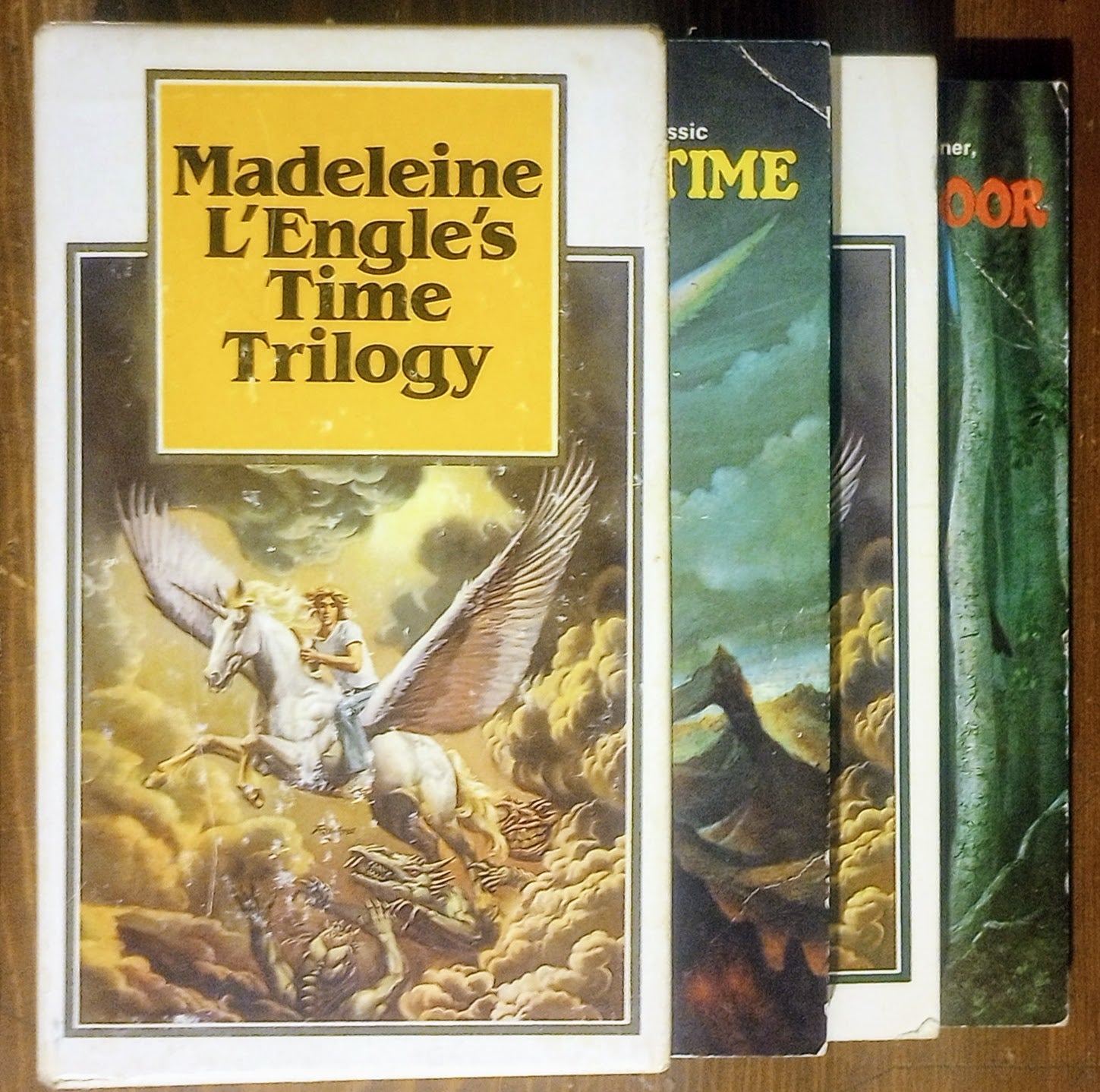 Book cover of 'Madeleine L'Engle's Time Trilogy' with a winged horse illustration on a fantasy background.