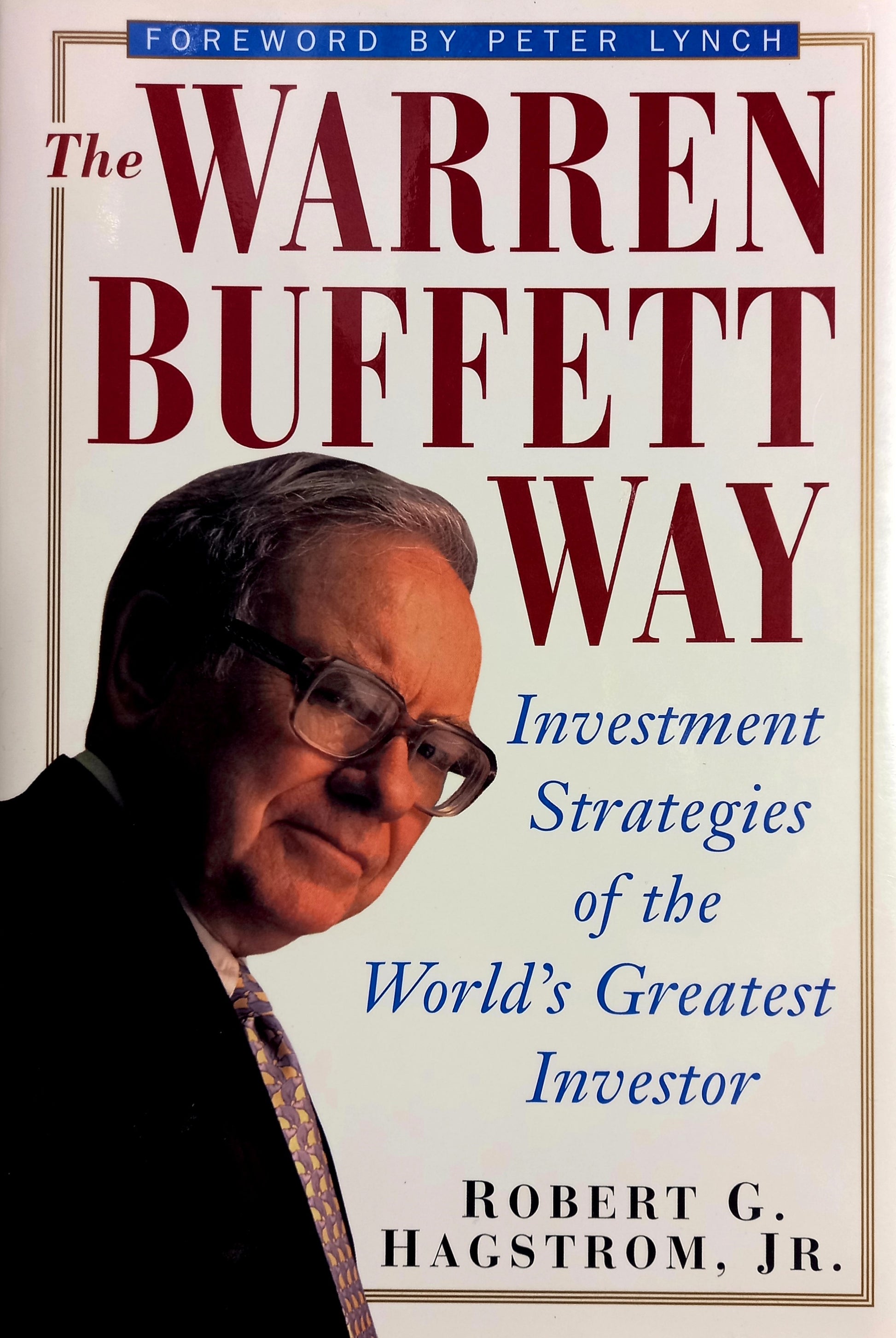 Book front cover of the book 'The Warren Buffett Way' by Robert G. Hagstrom, featuring a portrait of Warren Buffett with a subtle background.