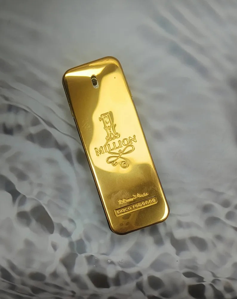 Gold bar bottle of '1 Million' by Paco Rabanne on a textured gray background.