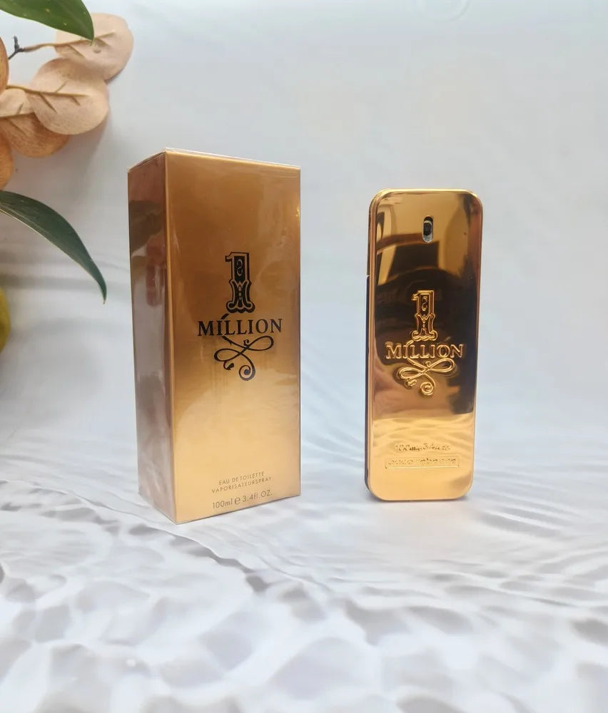 Gold '1 Million' perfume bottle and packaging on a white surface with leaves in the background