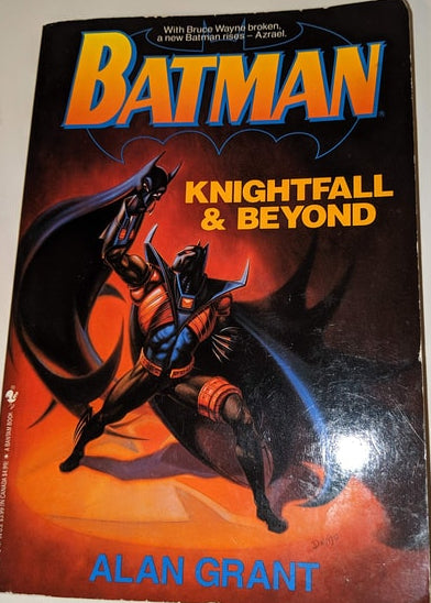 A book cover of 'Batman: Knightfall and Beyond' featuring artwork of Batman in a dynamic pose with a cityscape background.