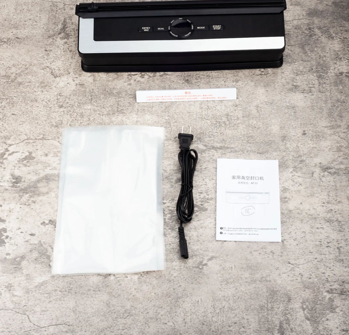 Sleek 135W LED vacuum sealer machine for household kitchen food storage with accessories on a concrete surface