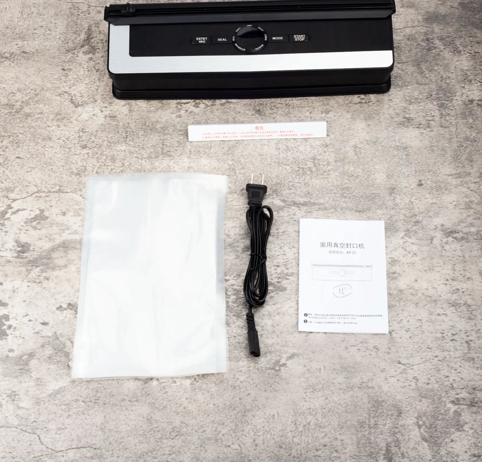Sleek 135W LED vacuum sealer machine for household kitchen food storage with accessories on a concrete surface