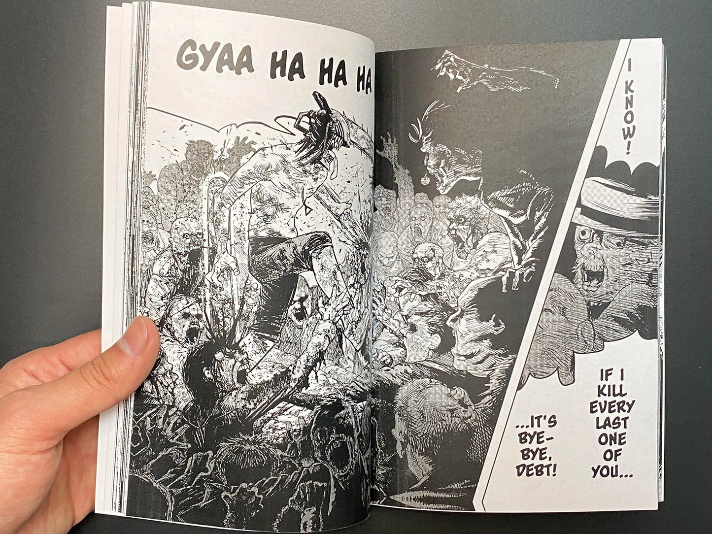 Open book with black and white illustrations and text on a dark background