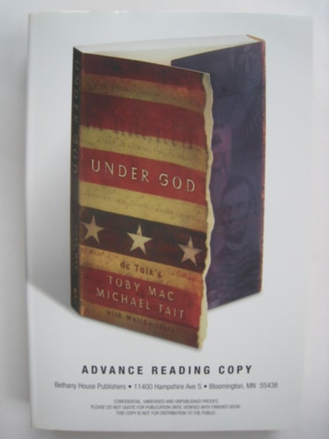 Book titled 'Under God' with a red, white, and blue design on a white background