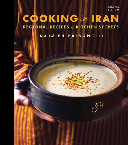 Book cover of 'Cooking in Iran' with a bowl of soup held by a person.