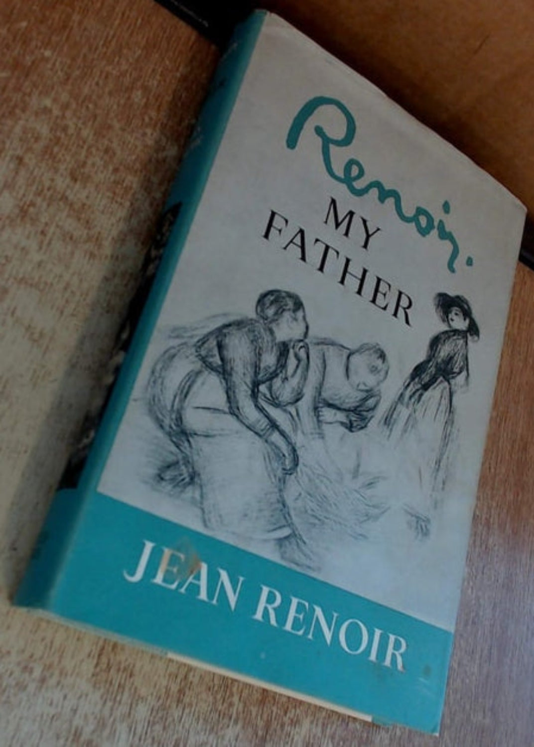 Book titled 'My Father' by Jean Renoir on a wooden surface