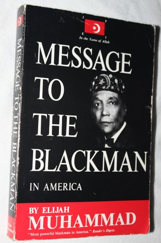 Book titled 'Message to the Blackman in America' by Elijah Muhammad on a black background