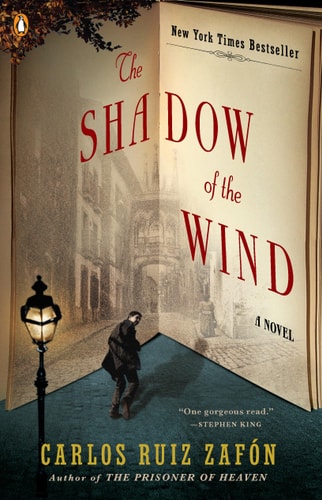 Book cover of 'The Shadow of the Wind' by Carlos Ruiz Zafón with a man walking on a street.