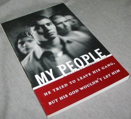 Book cover of " My People: he tried to leave his gang, but his God wouldn't let him" with black and white photo of two men and red text on a gray surface