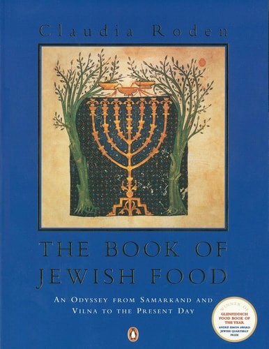 Book cover of 'The Book of Jewish Food' with a Menorah design on a blue background