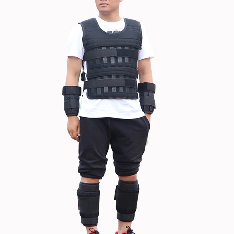 Person wearing a black weighted vest and arm sleeves on a white background