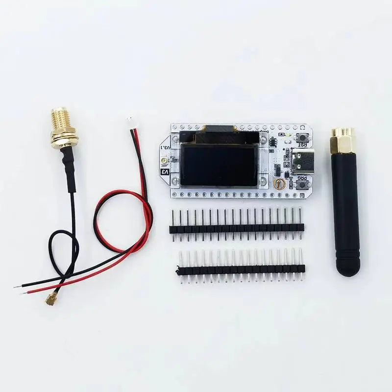 Electronic components including a microcontroller board, connectors, and antennas on a white background