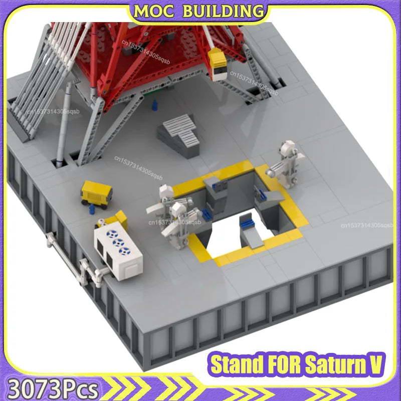 Model building kit stand for Saturn V with red and gray structure, workers, and vehicles on a white background.