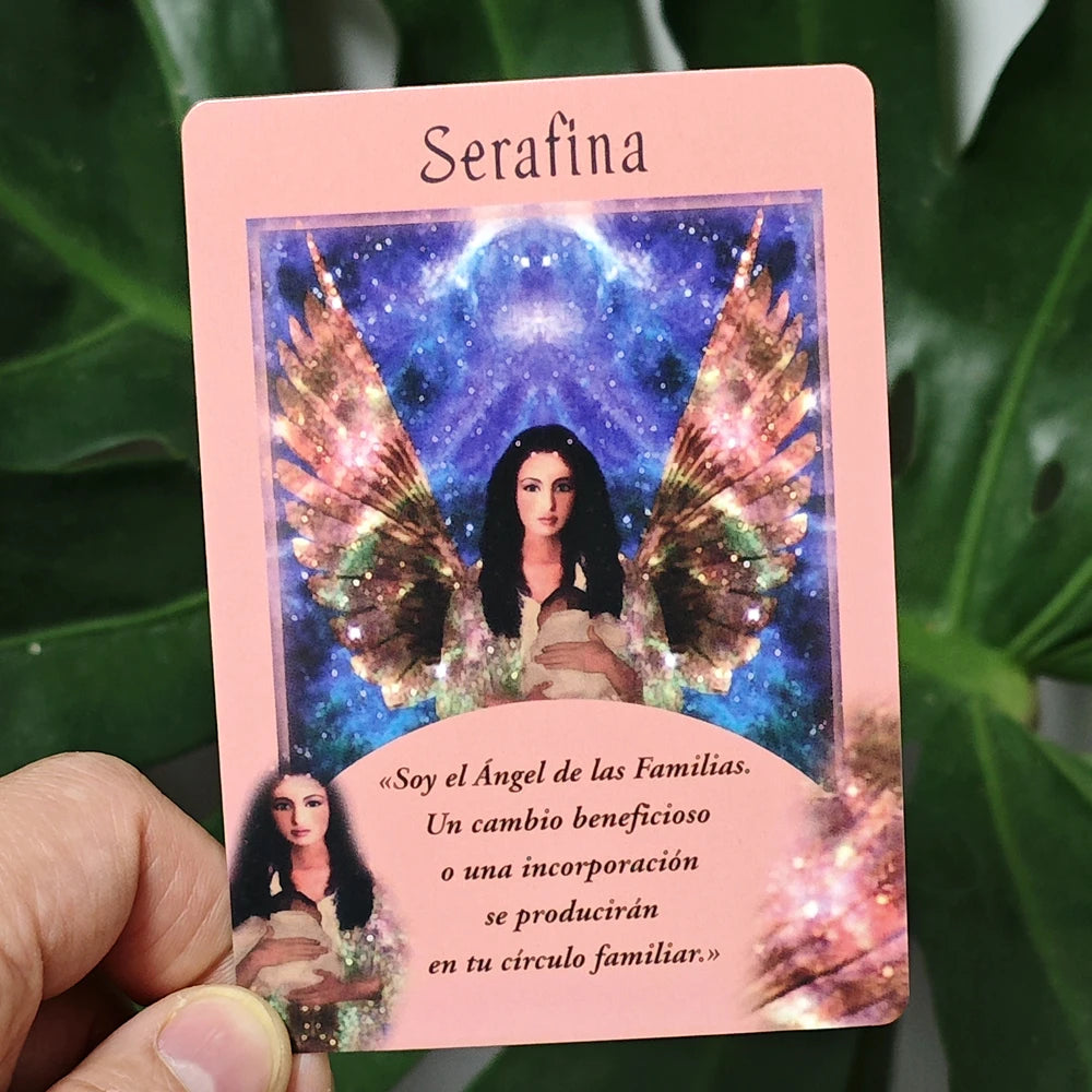 Card featuring an angel with wings titled 'Serafina' held by a hand against a green leafy background.