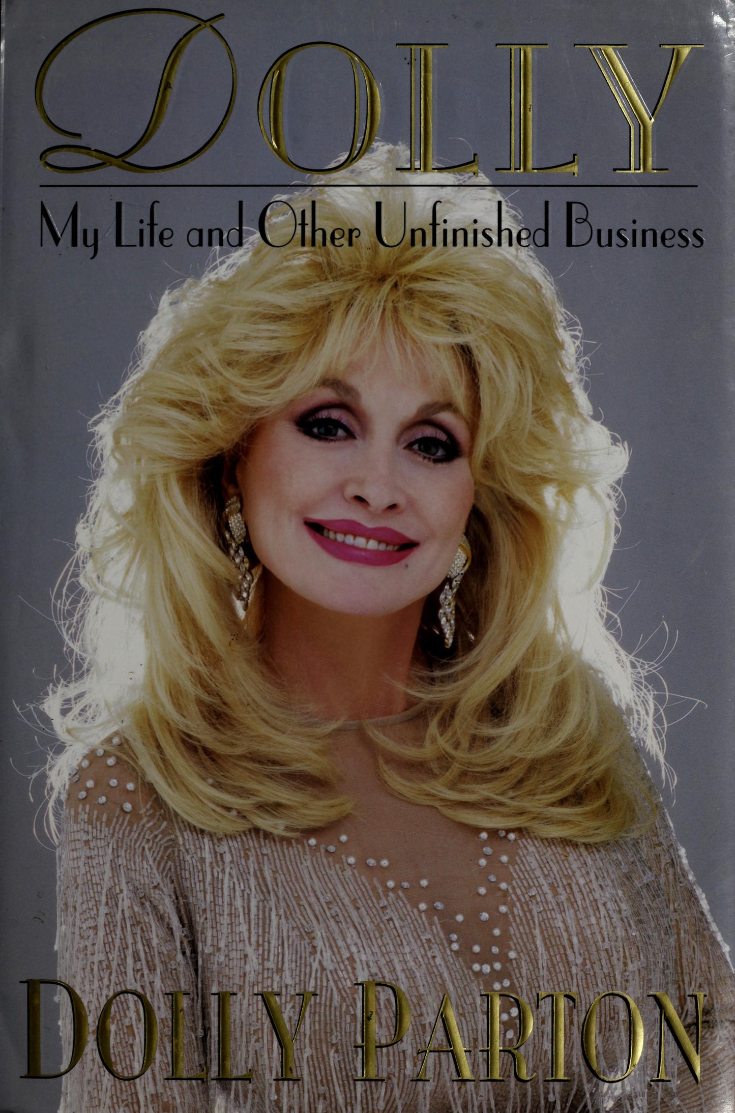 Book cover of 'Dolly: My Life and Other Unfinished Business' featuring Dolly Parton.