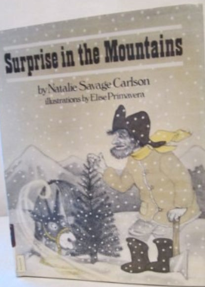 A book titled 'Surprise in the Mountains' with illustrations, featuring a character with a Christmas hat.