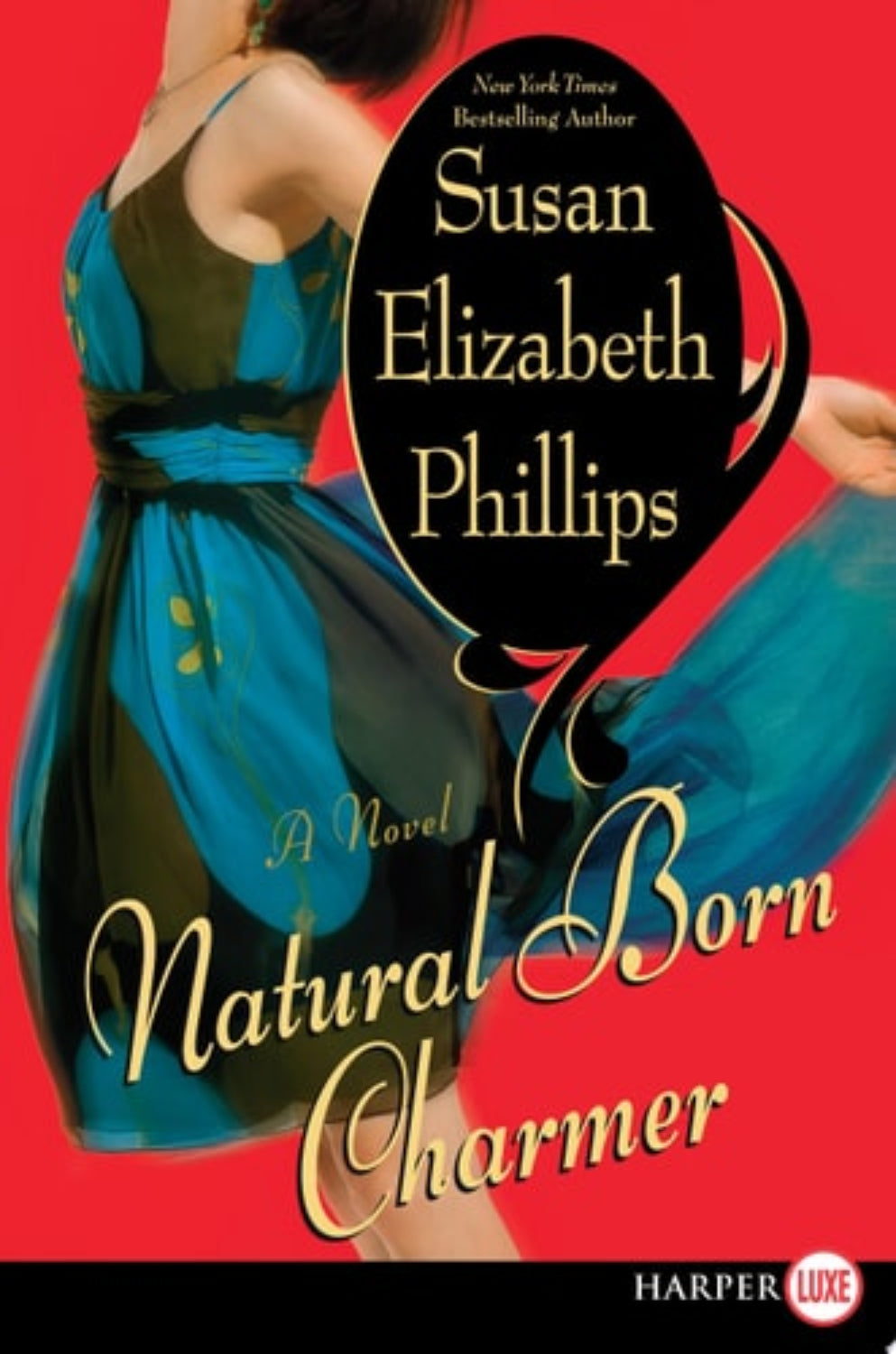 Book cover of 'Natural Born Charmer' by Susan Elizabeth Phillips with a woman in a blue dress on a red background.