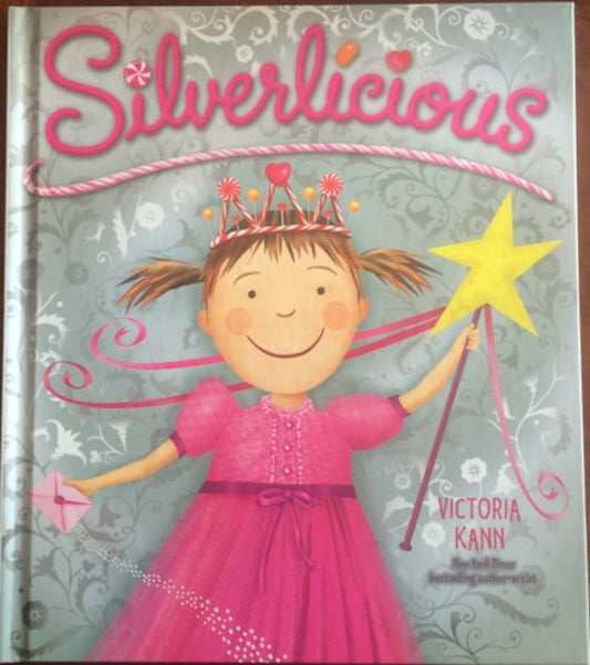 Cover of the book 'Silverlicious' featuring an illustration of a young girl with a pink dress and a crown, holding a star and a note, with decorative elements and a magical aesthetic.