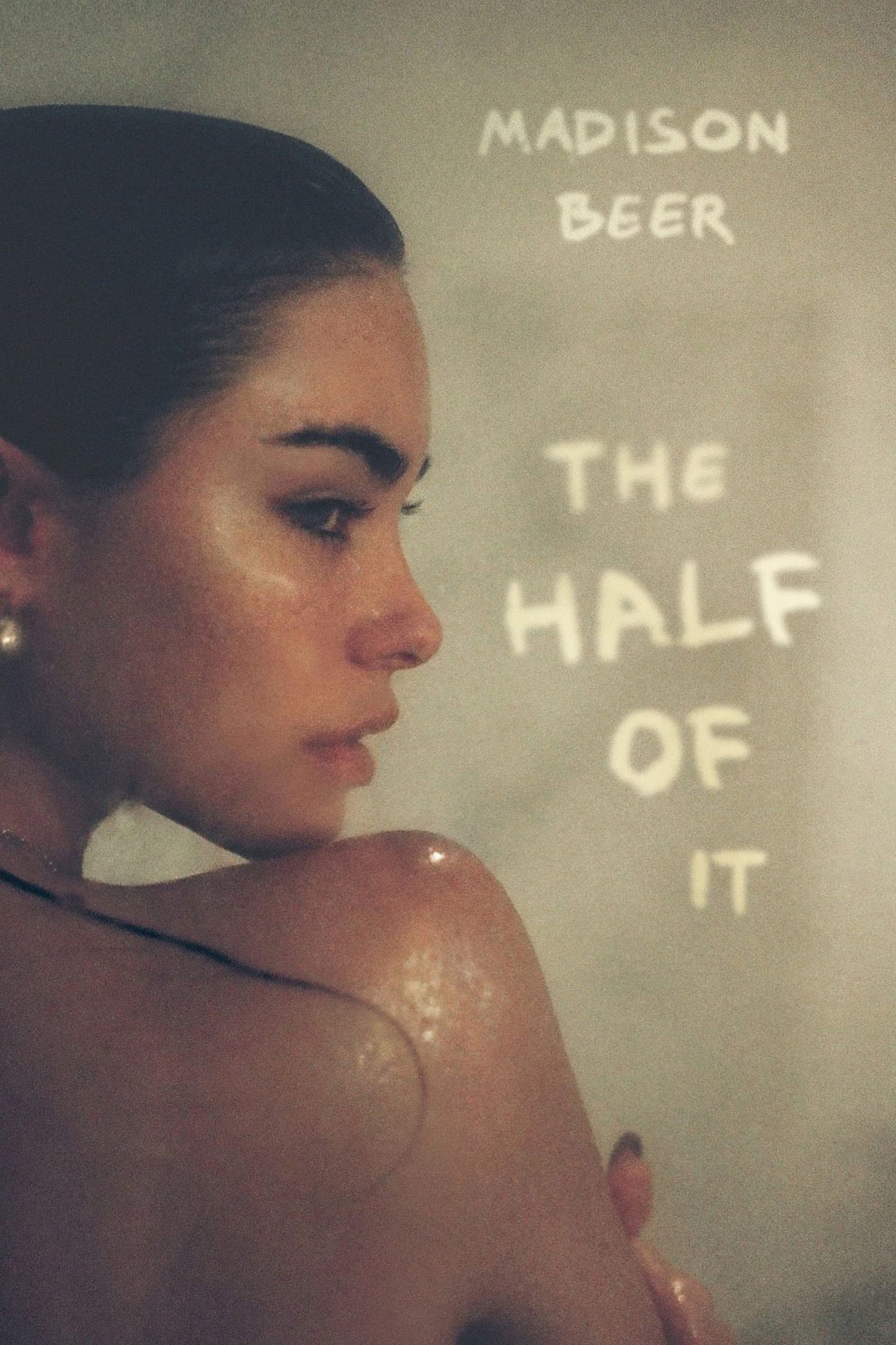 Person with text 'Madison Beer The Half Of It' on a textured background