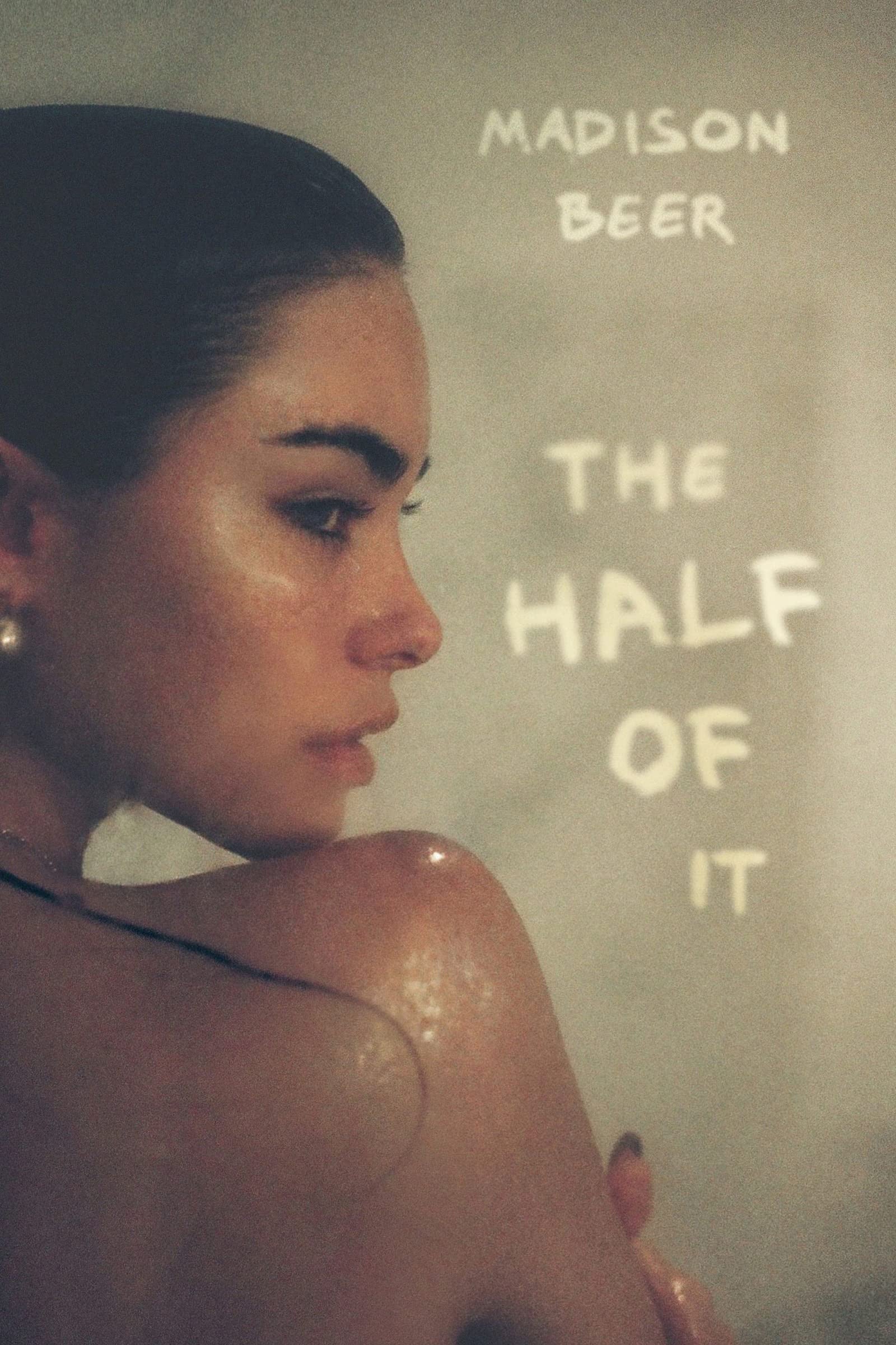 Person with text 'Madison Beer The Half Of It' on a textured background