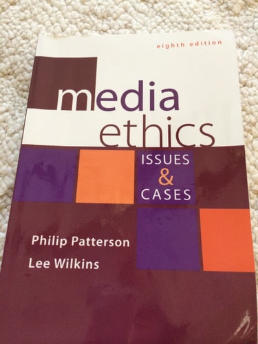 Book titled 'Media Ethics: Issues & Cases' by Philip Patterson and Lee Wilkins on a textured surface.
