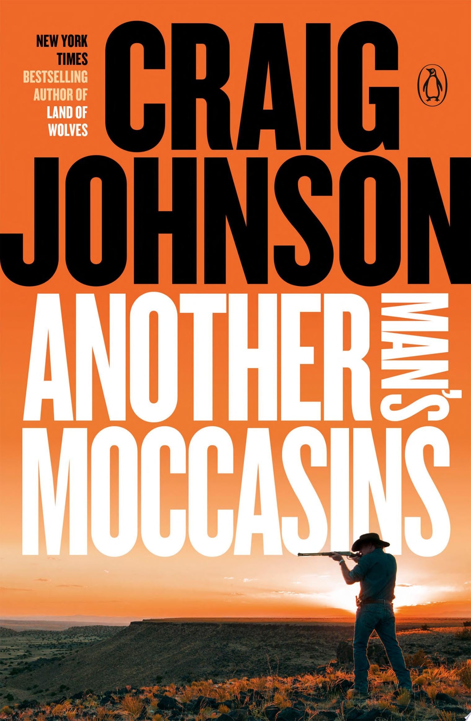Book cover of 'Another Man's Moccasins' by Craig Johnson with a silhouette of a person holding a rifle against an orange sky.